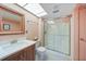 This bathroom features a sleek glass shower, a vanity with storage and modern fixtures at 2727 N Beach Rd # 113, Englewood, FL 34223