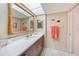 Tastefully remodeled bathroom with a dark wood vanity and well-lit countertop area at 2727 N Beach Rd # 113, Englewood, FL 34223