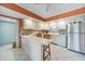 Bright kitchen features white cabinets, appliances, and a cozy breakfast bar with seating at 2727 N Beach Rd # 113, Englewood, FL 34223