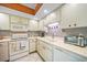 Classic kitchen design showcasing white appliances and cabinetry with modern backsplash detailing at 2727 N Beach Rd # 113, Englewood, FL 34223