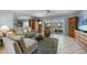 Cozy living room featuring tile floors, comfortable seating, and sliding glass doors to the balcony at 2727 N Beach Rd # 113, Englewood, FL 34223