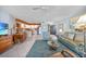 Bright living room with an open-concept layout, tile floors, and lots of natural light at 2727 N Beach Rd # 113, Englewood, FL 34223