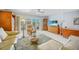 Inviting living room with a view of the balcony, comfortable seating, and plenty of natural light at 2727 N Beach Rd # 113, Englewood, FL 34223