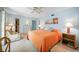 Cozy main bedroom with seating area, adjacent walk-in closet and dresser at 2727 N Beach Rd # 113, Englewood, FL 34223