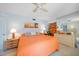 Comfortable main bedroom featuring sunset artwork and mirrored vanity with ample storage at 2727 N Beach Rd # 113, Englewood, FL 34223