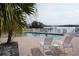 Community pool with palm trees and plenty of lounge seating near the water at 2727 N Beach Rd # 113, Englewood, FL 34223