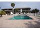 Inviting community pool surrounded by lush landscaping and comfortable lounge chairs at 2727 N Beach Rd # 113, Englewood, FL 34223