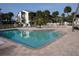 Community swimming pool surrounded by palm trees and plenty of seating at 2727 N Beach Rd # 113, Englewood, FL 34223