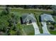 Aerial view of a single-Gathering home with driveway and landscaped yard at 3284 Newmark St, North Port, FL 34291