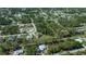 An aerial view of the property with a large, well-maintained yard and surrounded by lush greenery at 3284 Newmark St, North Port, FL 34291