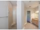 Bright bathroom featuring a glass door shower, tiled floors, and a modern vanity with neutral color palette at 3284 Newmark St, North Port, FL 34291