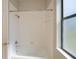 Clean bathroom with white tiled shower-tub, silver fixtures, and natural light at 3284 Newmark St, North Port, FL 34291