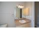 Neutral bathroom featuring a modern vanity, vanity cabinet, mirror and sconce lighting at 3284 Newmark St, North Port, FL 34291