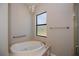 Bathroom showcases an inviting soaking tub beneath a window with a decorative chandelier and towel bar at 3284 Newmark St, North Port, FL 34291
