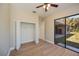 Bedroom with wood-look flooring, open closet and access to the screened patio at 3284 Newmark St, North Port, FL 34291