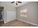 Neutral bedroom showcasing wood floors, a window with blinds, and white closet doors at 3284 Newmark St, North Port, FL 34291