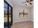 Bedroom with a ceiling fan, light-colored walls, and a view of the backyard at 3284 Newmark St, North Port, FL 34291