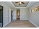 Bedroom with wood-look flooring, tray ceiling, and access to the other rooms and patio at 3284 Newmark St, North Port, FL 34291