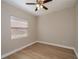 Bright bedroom with vinyl wood floors, ceiling fan and window with blinds at 3284 Newmark St, North Port, FL 34291
