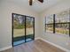 Bedroom with wood-look flooring, and access to the screened patio at 3284 Newmark St, North Port, FL 34291