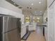 Kitchen with stainless steel appliances, white cabinetry, tiled floors, and sleek countertop at 3284 Newmark St, North Port, FL 34291