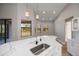 Kitchen featuring white cabinets, sleek countertop, pendant lighting, and a breakfast bar at 3284 Newmark St, North Port, FL 34291