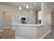 Kitchen island featuring white cabinets, pendant lighting, and a breakfast bar with sleek countertops at 3284 Newmark St, North Port, FL 34291