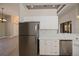 Kitchen with stainless steel appliances, white cabinetry, sleek countertops, and view to the living area at 3284 Newmark St, North Port, FL 34291