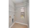Functional laundry area with shelves and a window for natural light at 3284 Newmark St, North Port, FL 34291