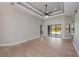 Bright living room with decorative ceilings, modern flooring, and access to the patio at 3284 Newmark St, North Port, FL 34291