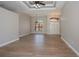 Open living room with wood-look flooring, arched windows, and decorative ceilings at 3284 Newmark St, North Port, FL 34291
