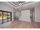 Open living space with bar seating, tray ceilings, and access to outdoor area at 3284 Newmark St, North Port, FL 34291