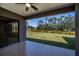 Covered patio overlooking the lush green lawn and scenic landscape at 3284 Newmark St, North Port, FL 34291