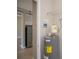 Utility area featuring a water heater with stainless steel refrigerator at 3284 Newmark St, North Port, FL 34291