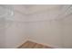 Walk-in closet featuring white wire shelving, vinyl wood floor and ample storage for clothes at 3284 Newmark St, North Port, FL 34291