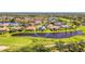 Aerial view of single Gathering home in a golf course community with large pond behind it at 3574 Pennyroyal Rd, Port Charlotte, FL 33953