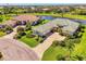 A lovely golf course property featuring lush landscaping and a long driveway leading up to a well maintained home at 3574 Pennyroyal Rd, Port Charlotte, FL 33953