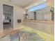 Bathroom featuring double vanity, bright lighting, and decorative rug at 3574 Pennyroyal Rd, Port Charlotte, FL 33953