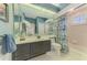 Bright bathroom features a large mirror, single sink vanity, and shower-tub combo at 3574 Pennyroyal Rd, Port Charlotte, FL 33953