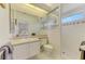 Bathroom features a sink with a large mirror, toilet, and stand-up shower at 3574 Pennyroyal Rd, Port Charlotte, FL 33953