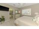 Bedroom features a large window, comfy bed, and ensuite bathroom at 3574 Pennyroyal Rd, Port Charlotte, FL 33953
