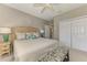 Bedroom boasts neutral walls, a ceiling fan, a cozy bed, and carpet flooring at 3574 Pennyroyal Rd, Port Charlotte, FL 33953