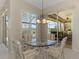 Cozy breakfast nook with a glass table and views of the patio and pool at 3574 Pennyroyal Rd, Port Charlotte, FL 33953
