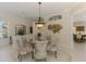 Charming dining room features unique lighting and a stylish design at 3574 Pennyroyal Rd, Port Charlotte, FL 33953