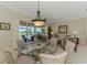 Elegant dining area offers stylish furnishings and serene backyard views at 3574 Pennyroyal Rd, Port Charlotte, FL 33953