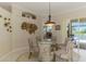 Stylish dining area with unique artwork and access to outdoor living spaces at 3574 Pennyroyal Rd, Port Charlotte, FL 33953