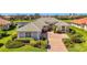 Beautiful single Gathering home with a lush landscaped yard and paver driveway at 3574 Pennyroyal Rd, Port Charlotte, FL 33953