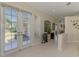 Foyer boasts neutral paint, tile floors, and beautiful doors leading to the outdoor area at 3574 Pennyroyal Rd, Port Charlotte, FL 33953