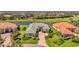 A beautiful single Gathering home, with a well manicured front yard, is next to a large pond at 3574 Pennyroyal Rd, Port Charlotte, FL 33953