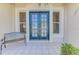 Covered front porch with double door entrance and tiled flooring at 3574 Pennyroyal Rd, Port Charlotte, FL 33953